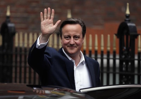 Britain's PM Cameron waves as he leaves the Conservative Party headquarters in London