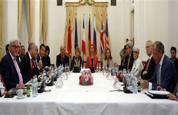 German Foreign Minister Frank-Walter Steinmeier, left, French Foreign Minister Laurent Fabius, 2nd left, Chinese Foreign Minister Wang Yi, 3rd left, European Union foreign policy chief Federica Mogherini, centre in red, U.S. Secretary of State John Kerry, 4th right, and Russian Foreign Minister Sergei Lavrov, right, meet at a hotel in Vienna. (Photo: AP)