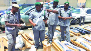Customs officers inspecting the rifles